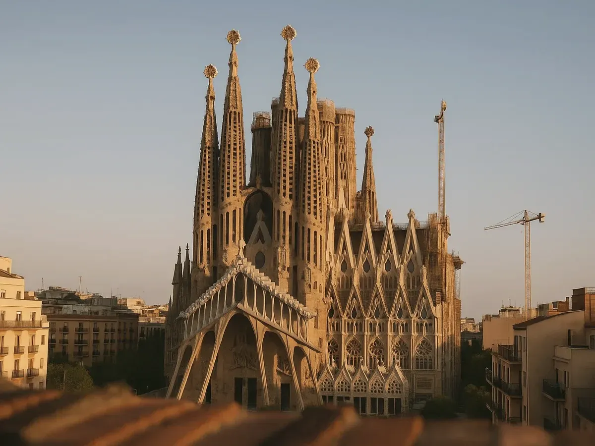 The towers of the Sagrada Família at sunset with a construction crane beside them