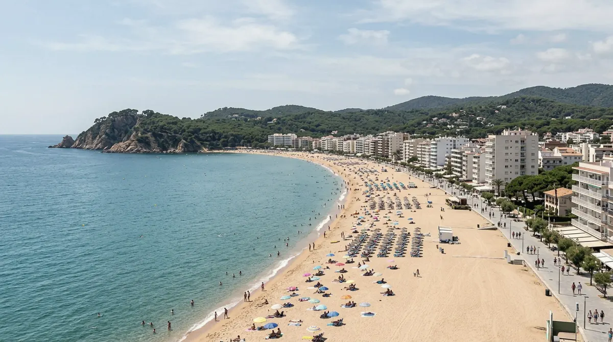 The long sandy beach of Platja d'Aro with apartment buildings and hotels along the seafront